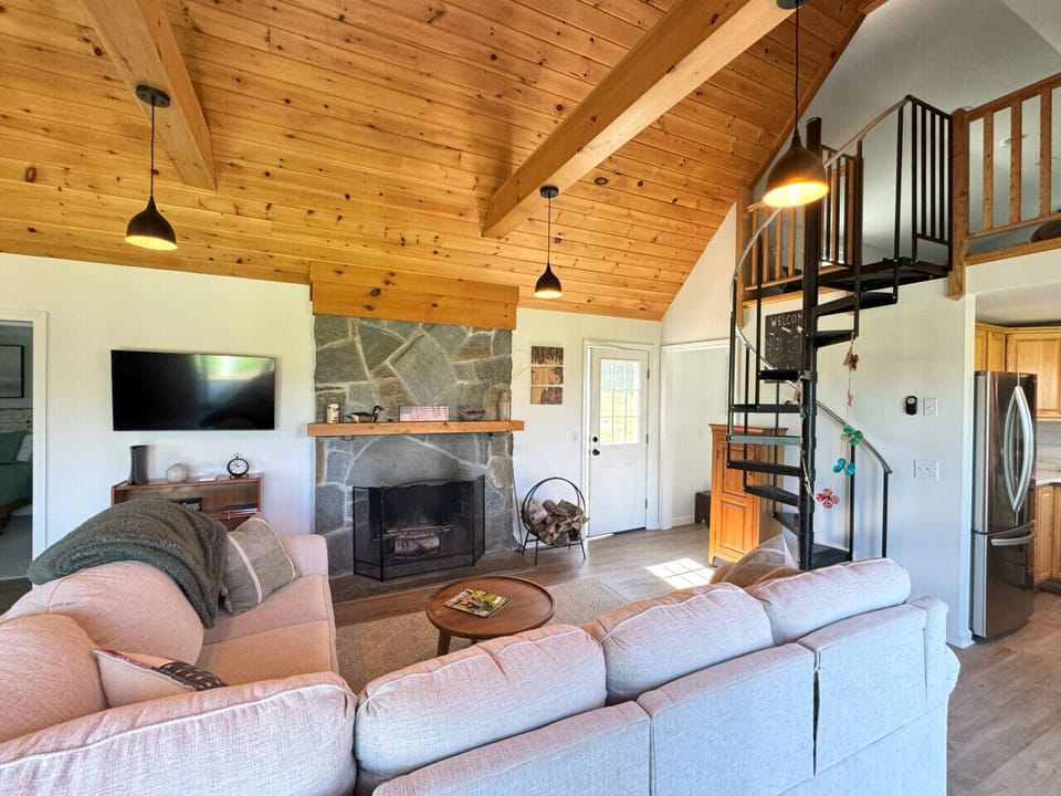 Living room with wood burning fireplace & 55` Smart TV