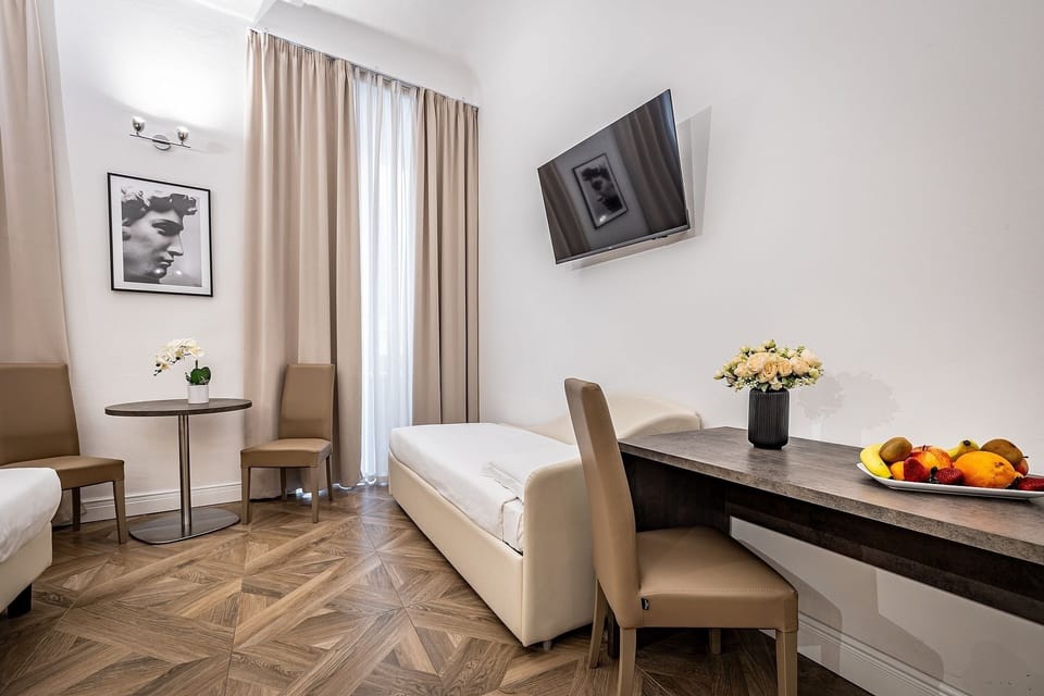 Quadruple Room | Minibar, in-room safe, individually decorated, desk