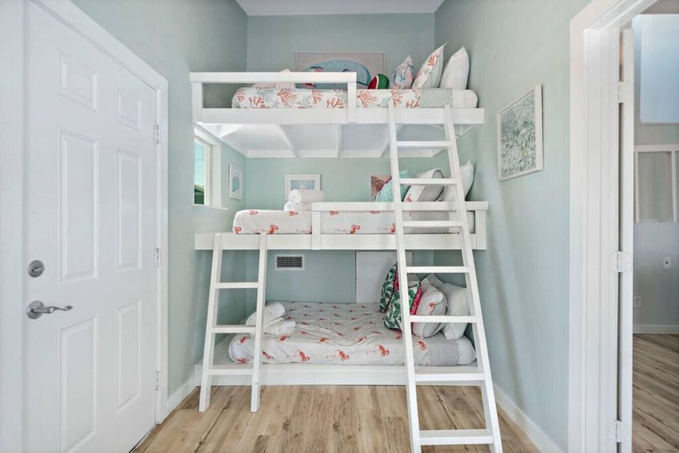 This bedroom has a triple full-size bunk bed