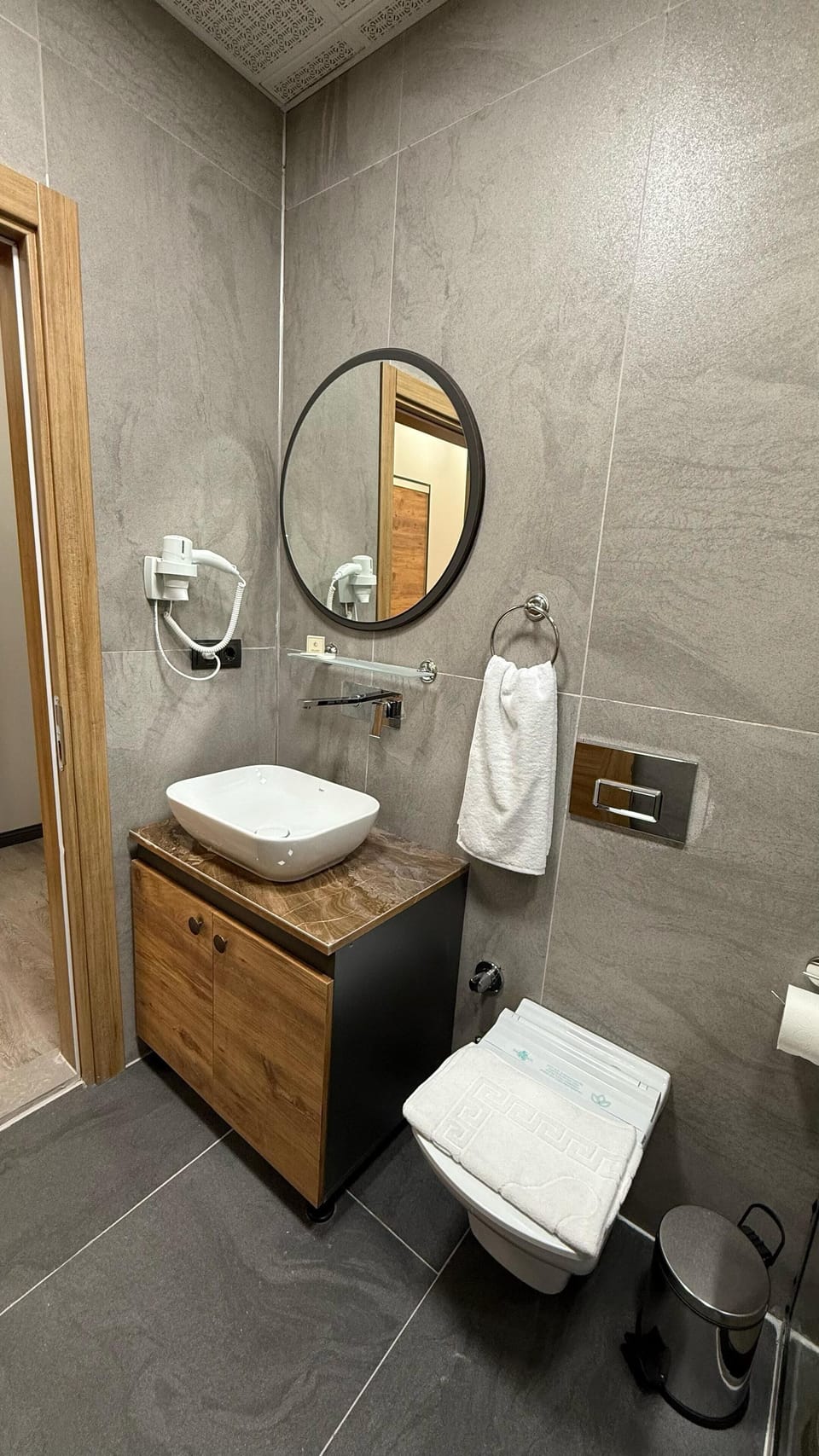 Shower, hair dryer, slippers, towels