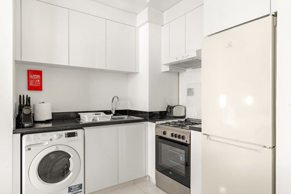 Kitchen: Modern appliances and sleek design await your culinary adventures in Dubai!