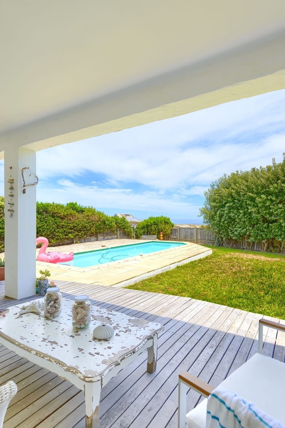 Verandah, pool, garden with trampoline leads directly onto the beach