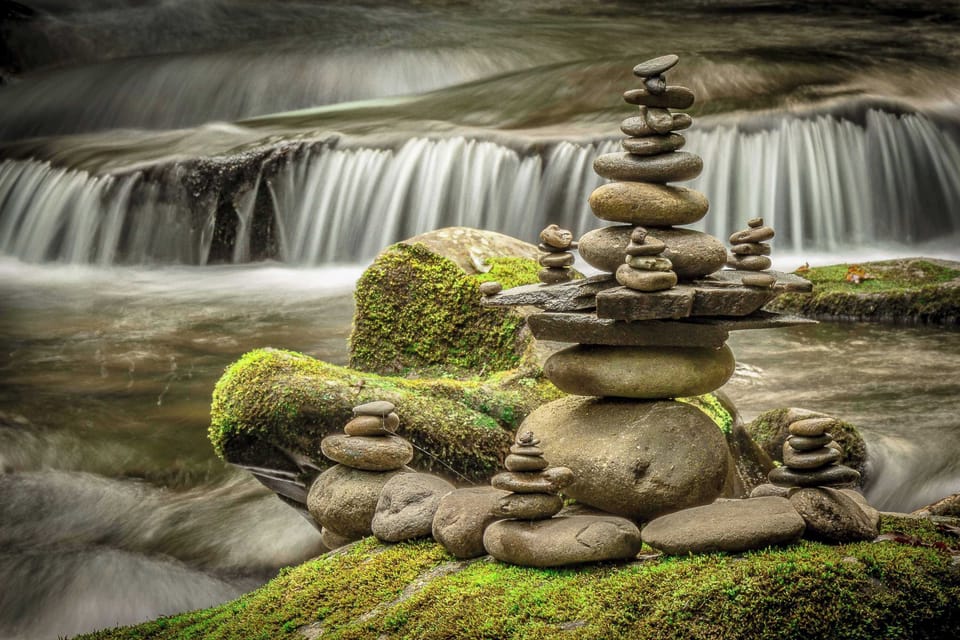 Discover serene stone towers by the picturesque stream, perfect for relaxation!