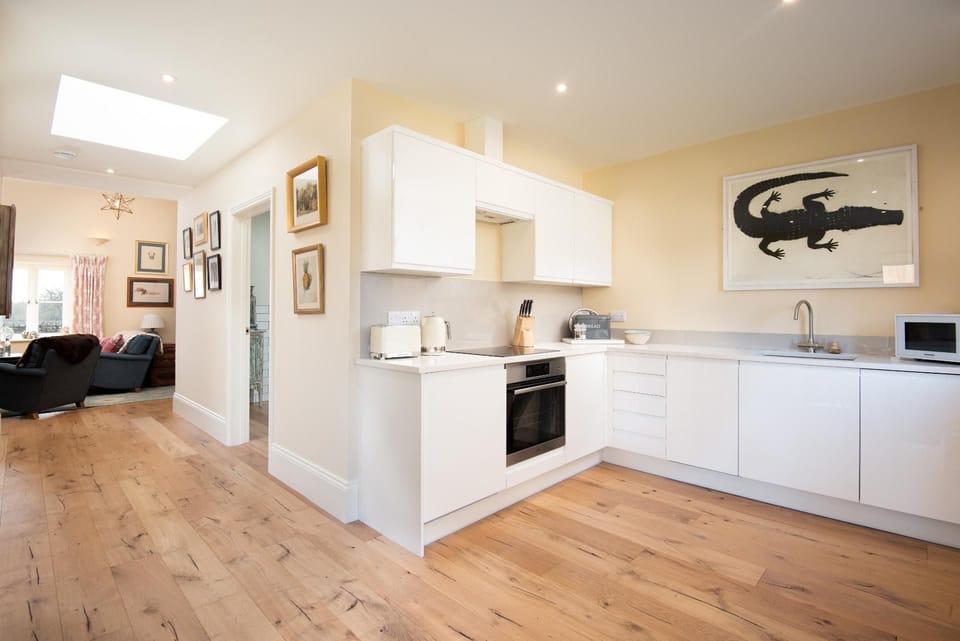 Lakeside Cottage - Emily - the kitchen and dining space leads through to the sitting room