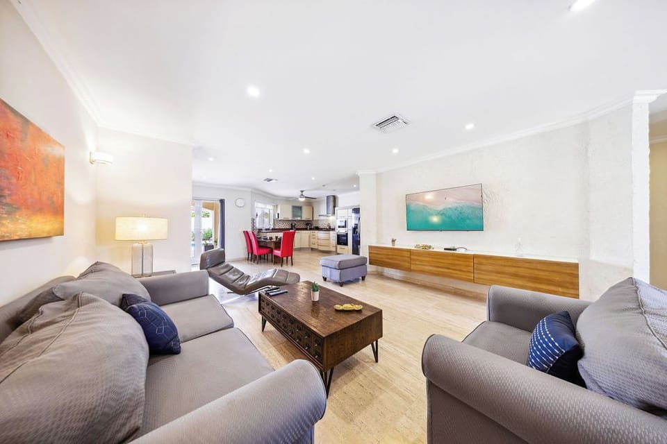 Sink into plush sofas and unwind in this bright, open living space where colorful art and warm wood tones create the perfect backdrop for your memorable stay.