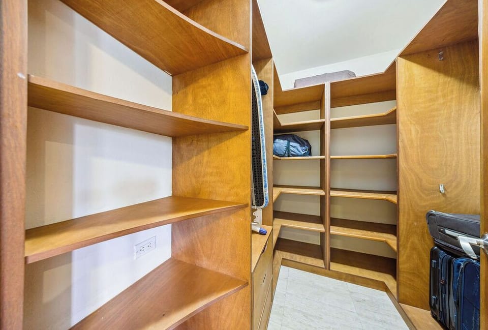 Generous walk-in closet with custom shelving ensures your belongings stay organized and easily accessible throughout your stay.