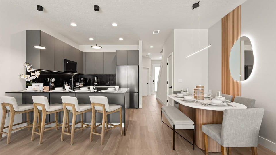 Kitchen with breakfast bar seating and luxury dining area