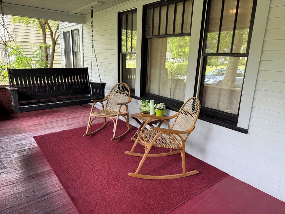 Two rockers and the vintage swing out front and 6 additional seats back,firepit