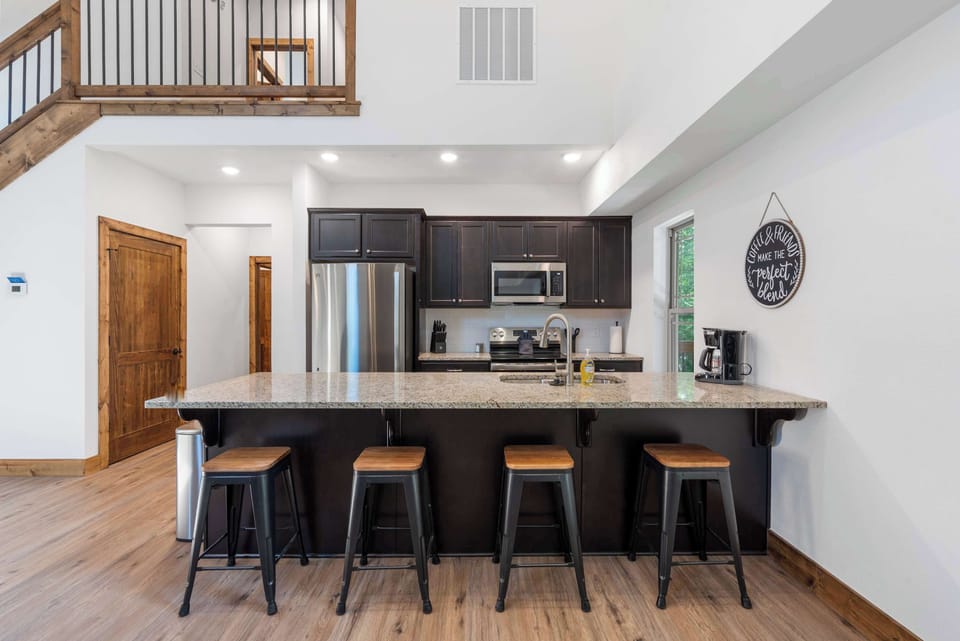 The chic, open kitchen offers ample space & every home comfort