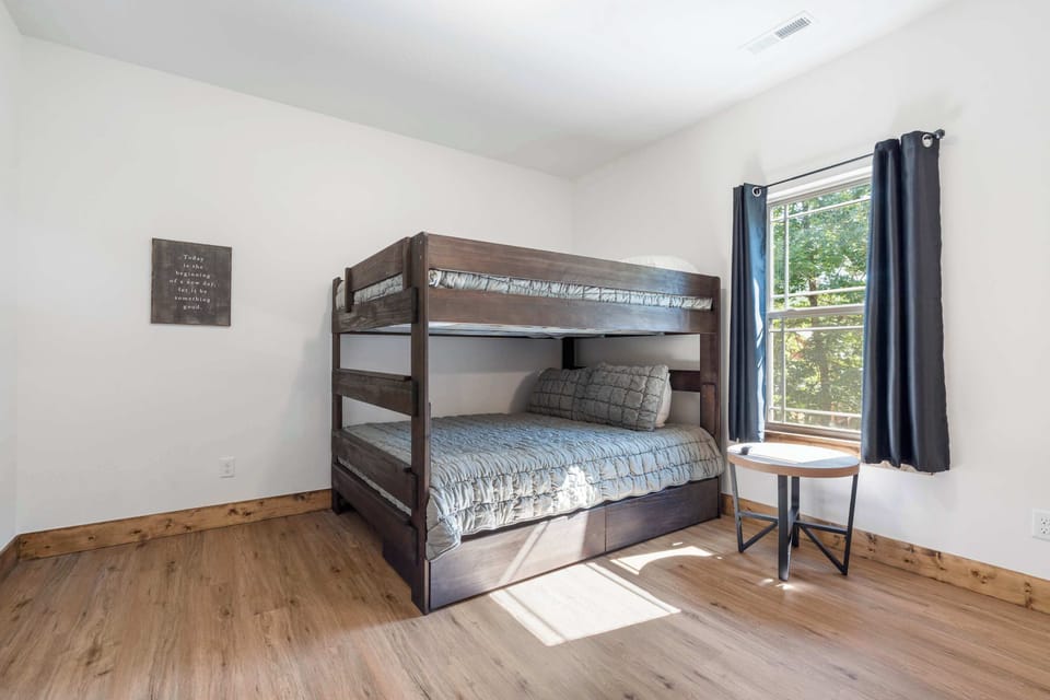 The final suite includes queen bunks, a smart TV, & an ensuite bath