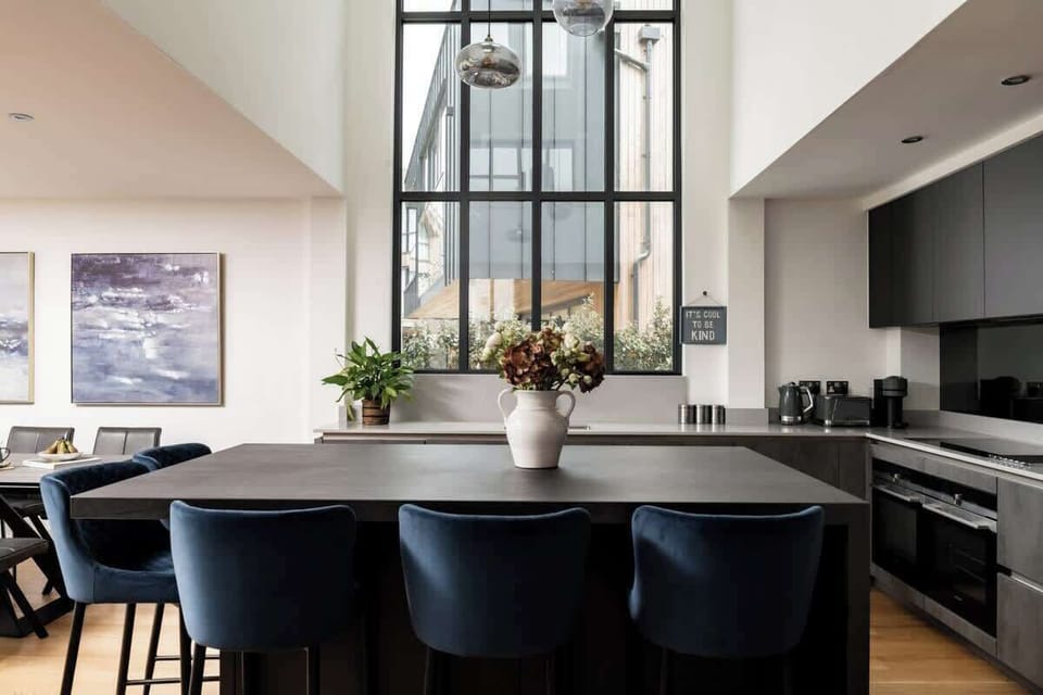 Velvet bar stools, clean lines, and space to gather. Effortless living starts here, and so do tasty feasts.