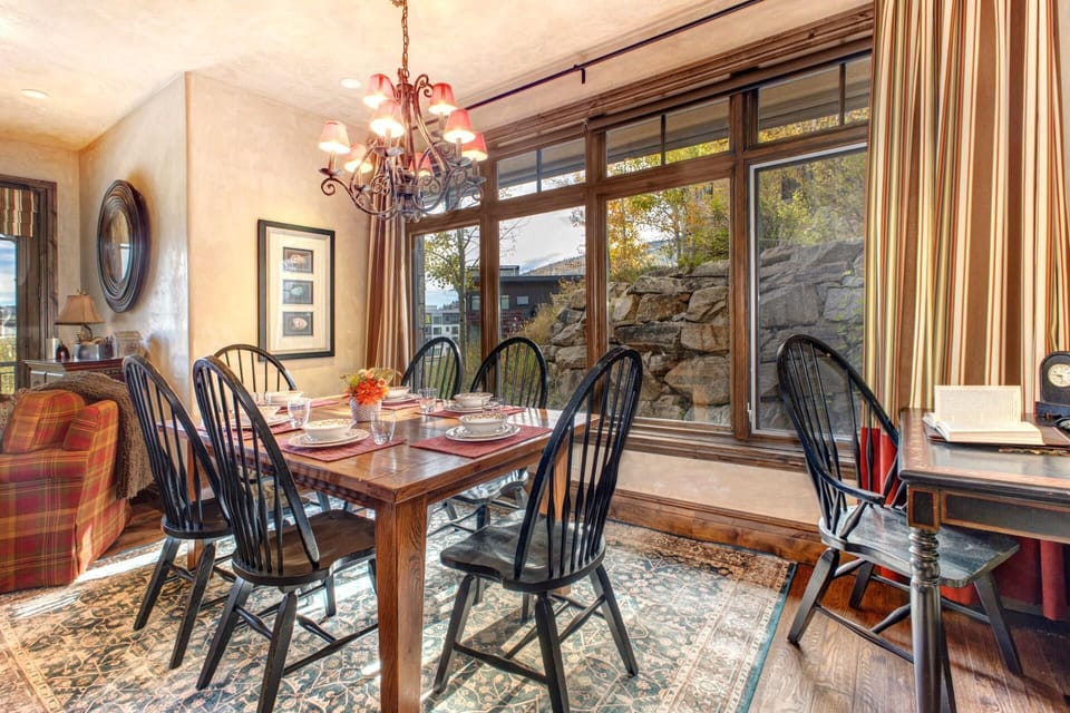 Gather at the elegant dining table with forest views and soft lighting for après-ski dinners or game night. VIN-14