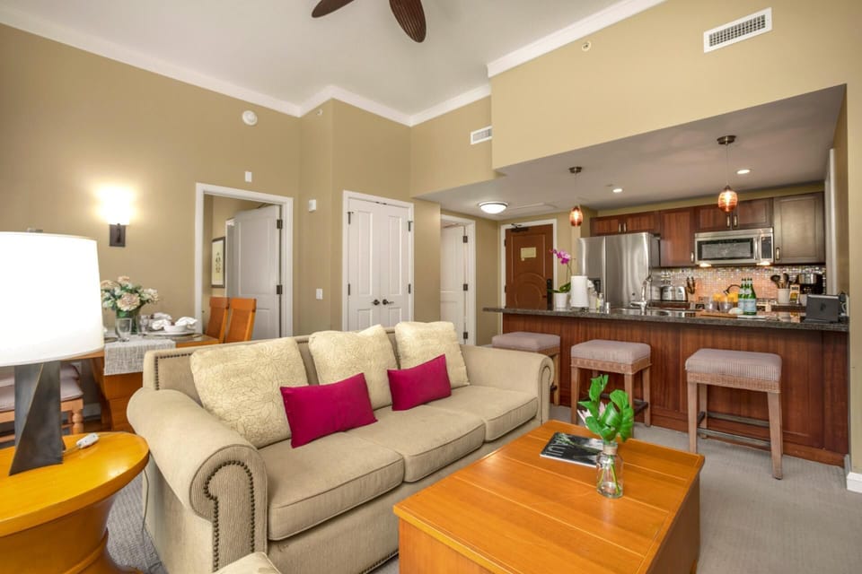 Open-concept living area featuring direct access to the patio, natural light, and a tropical ambiance HKH-114