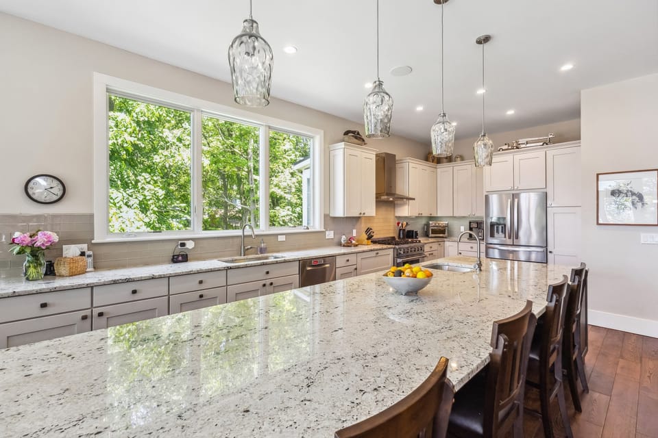 Stylish kitchen featuring a large island for prep and dining.