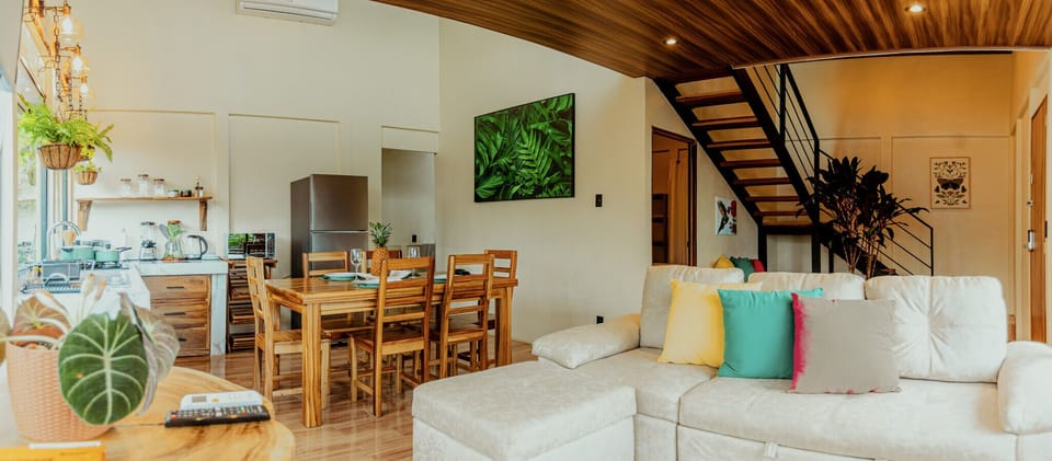 Living and kitchen area with staircase to loft bedroom