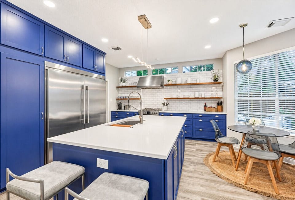 Stunning Kitchen with Designer Blue Island and Modern Lighting