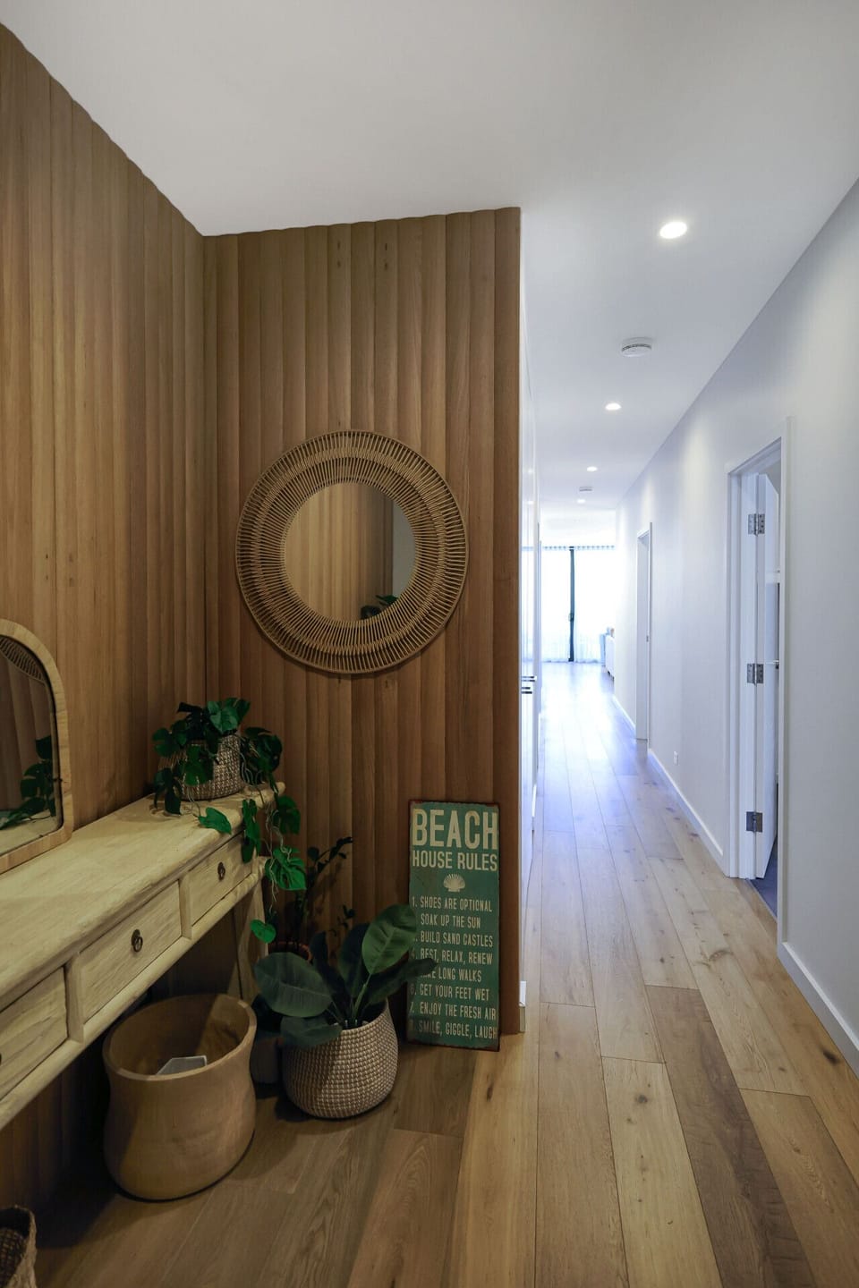 Welcoming hallway with warm wood feature wall and stylish decor