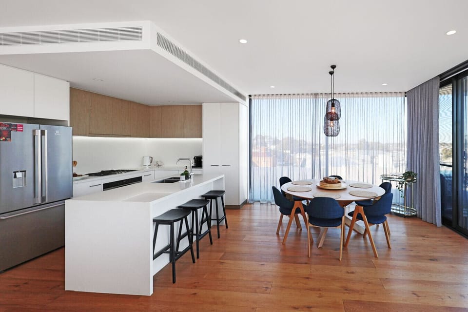 Open kitchen with breakfast bar and dining space, perfect for shared meals