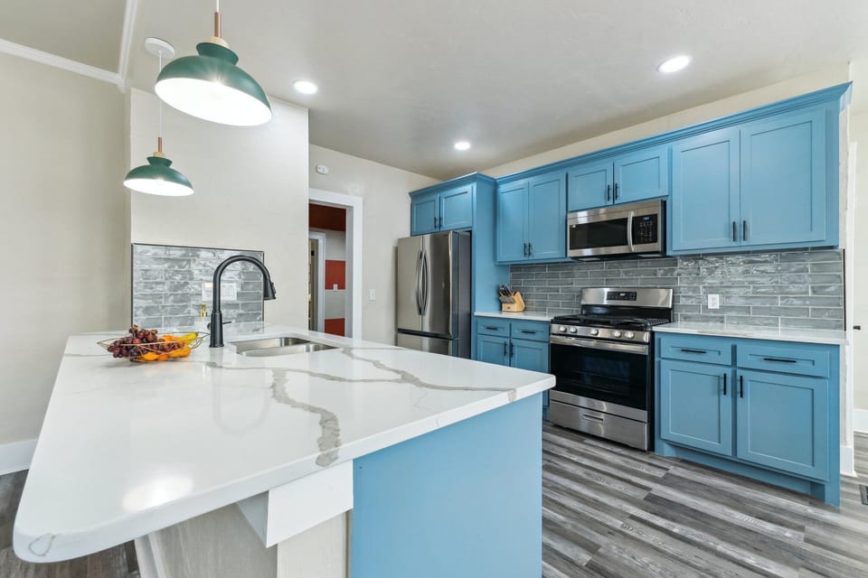 Granite counter tops, large peninsula, gas range and large fridge. 