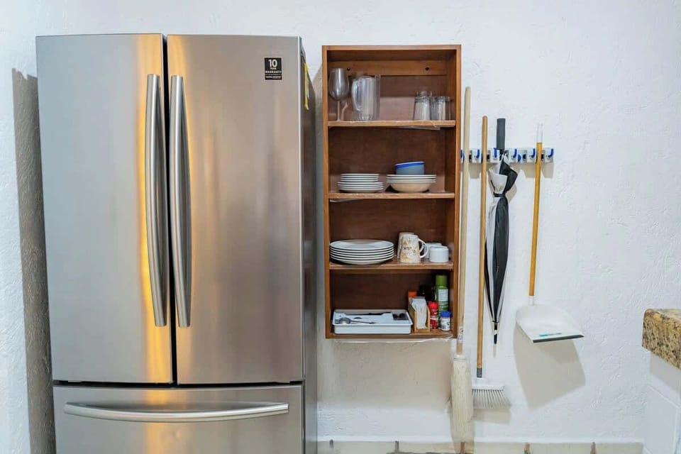 Kitchen with refrigerator and storage
