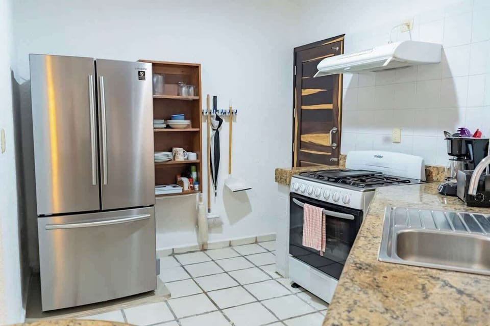 Fully equipped kitchen with refrigerator