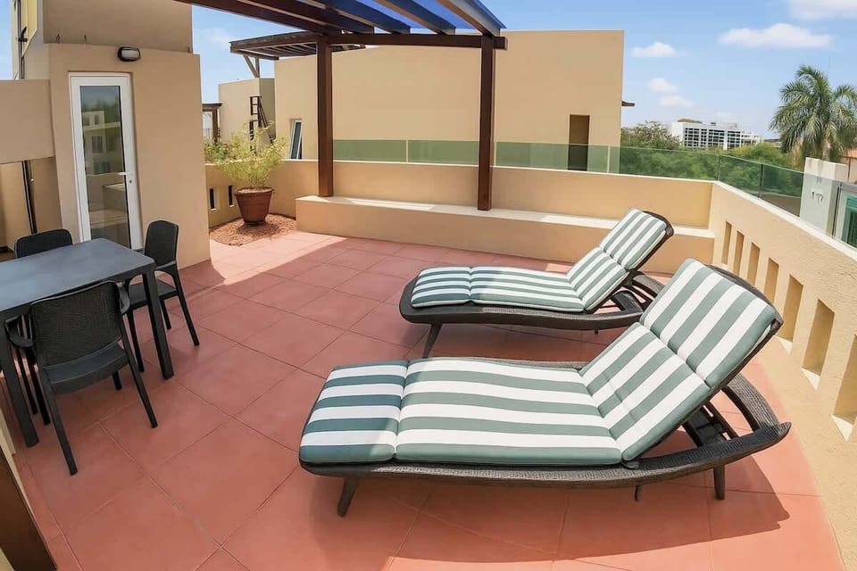 Private rooftop terrace with sun loungers.