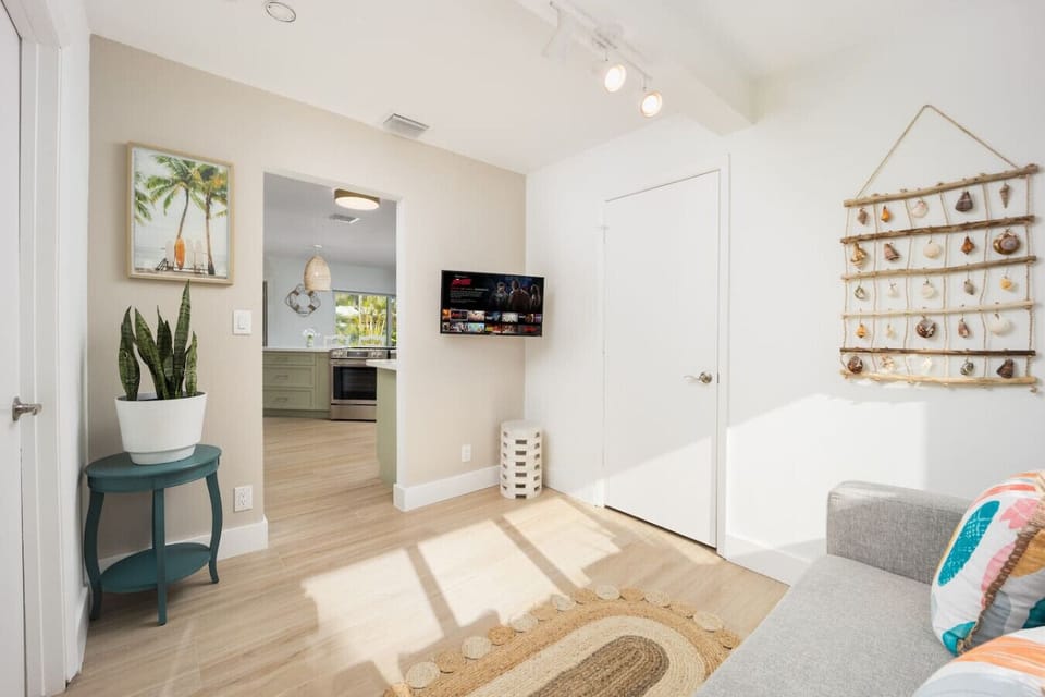 Sunroom with full view of the TV and direct access to the kitchen—great for relaxing, catching a show, or keeping connected while others prep meals.
