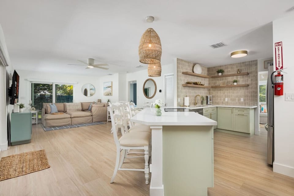 Newly renovated kitchen with sage cabinetry, open shelving, and boho coastal touches throughout. We provide all the cookware and essentials so you can settle in and feel at home.