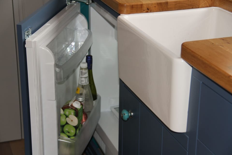 Kitchen area with a small fridge