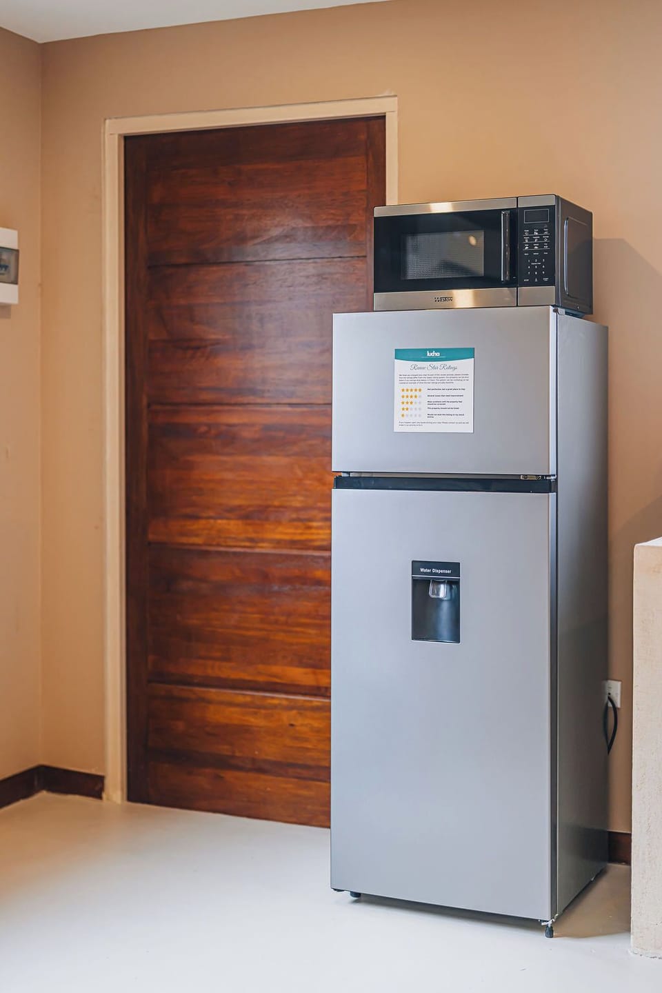 Modern kitchen essentials including a full-size fridge and microwave to make meal prep easy.

