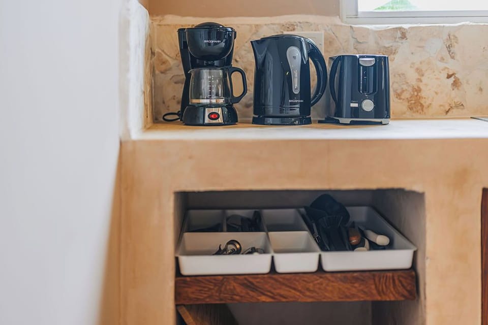 A full coffee and tea station with kettle, coffee maker, and storage for all your brewing essentials.



