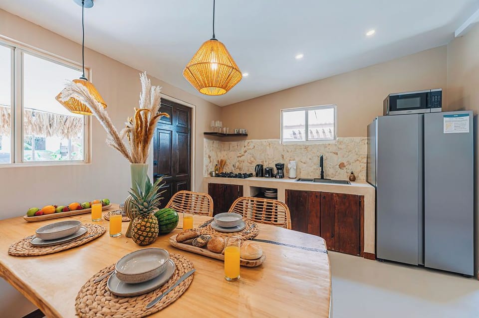 Beautifully styled dining table set for a cheerful meal, surrounded by natural textures and light.

