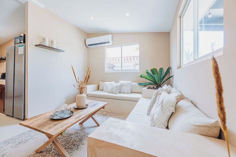 Bright and stylish living room with minimalist design, ideal for relaxing, reading, or enjoying a quiet moment.

