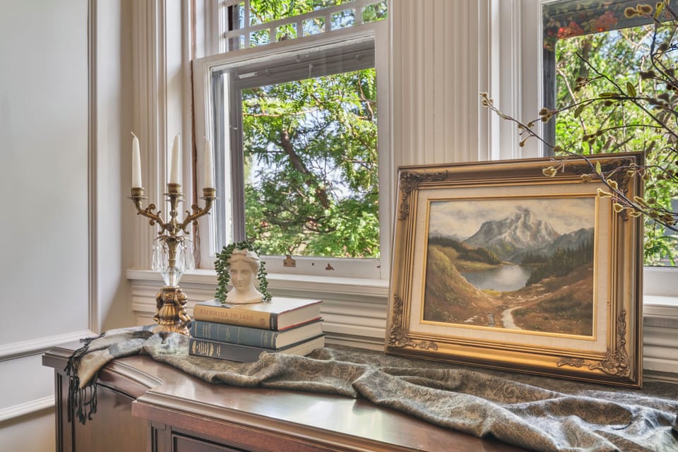 The center of the home is dominated by a grand and ornate hand carved staircase with Tiffany chandeliers and numerous fine details