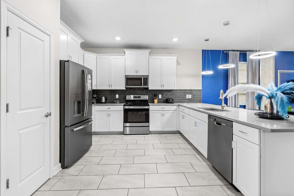 Fully equipped kitchen with modern appliances and spacious layout.