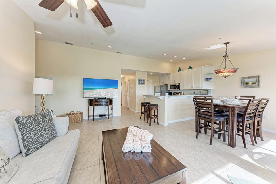 Relax in your spacious open-concept living area where coastal comfort meets modern elegance, perfect for gathering with loved ones.