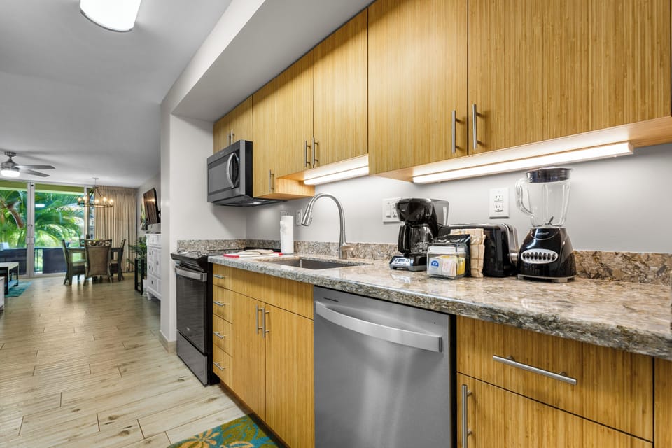 Your modern kitchen features stainless steel appliances, sleek granite countertops, and warm wood cabinetry—perfect for brewing morning coffee or preparing vacation meals with family.