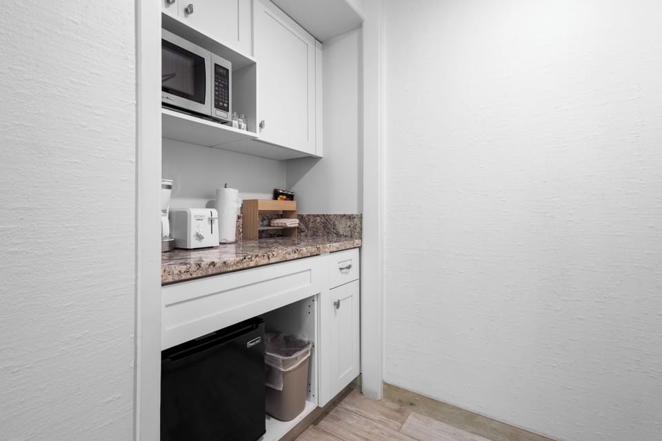 Your cozy kitchenette is fully equipped with everything you need—microwave, coffee maker, mini fridge, and granite counters ready for easy meal prep and morning coffee.