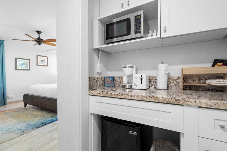 Your compact kitchenette comes fully equipped with microwave, toaster, and coffee maker—everything you need to start your day right. A mini-fridge keeps your drinks chilled and ready whenever you are.