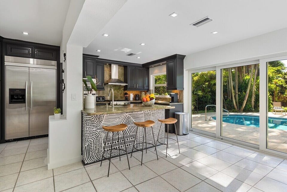 Clean, sleek, and accompanied by the perfect breakfast bar for casual dining moments.