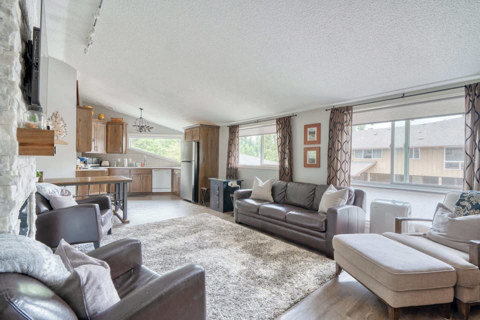 Living room with sofa and kitchen view.