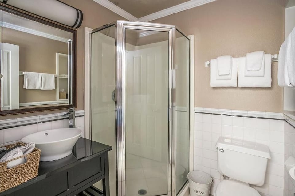 Rinse off in the bright glass shower with fresh linens ready.