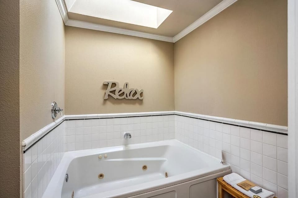 Soak and relax in the oversized jetted tub beneath skylight.