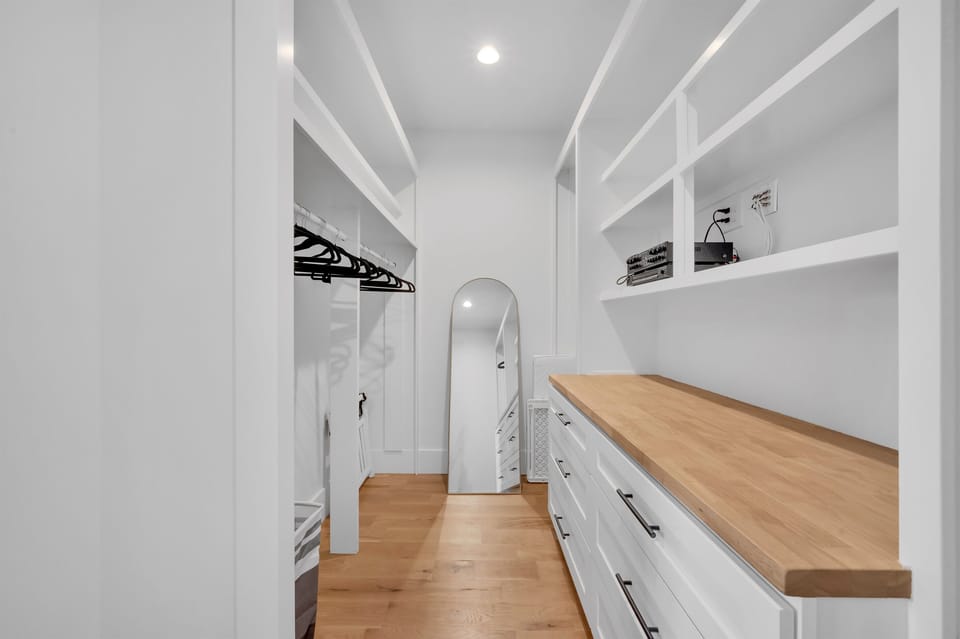The large walk in closet in the primary bedroom provides ample storage space and room to change.  The control for the audio system is accessible here, controlling music on the main floor.