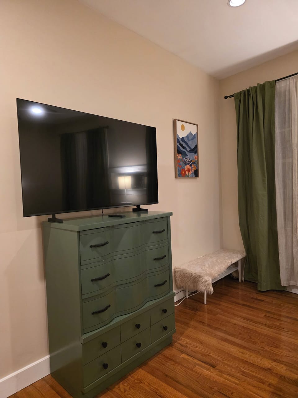 Refinished antique dresser with 55" smart TV.