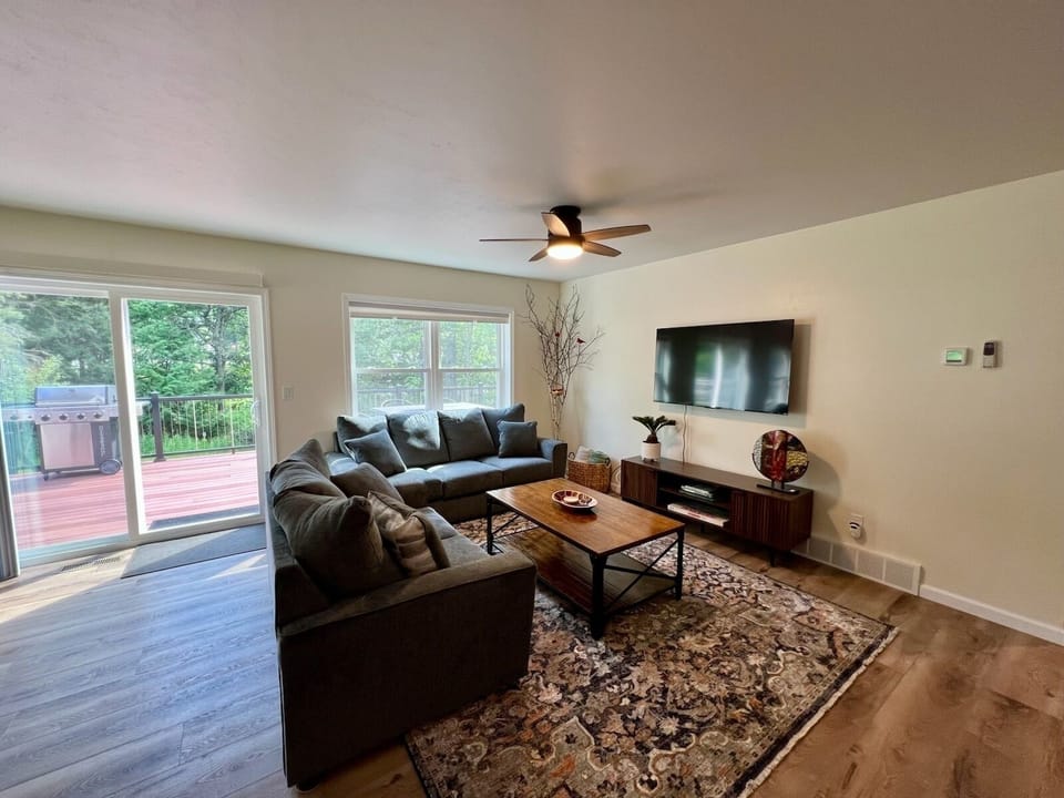 Living room with smart TV & board games. Access to back porch
