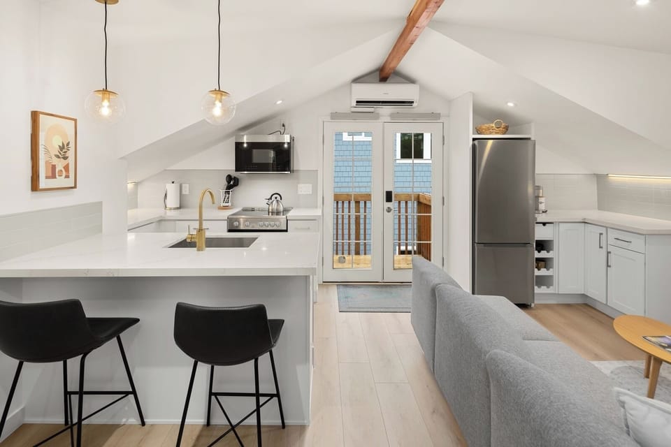 Pendant lighting sets the tone over quartz counters and barstool seating