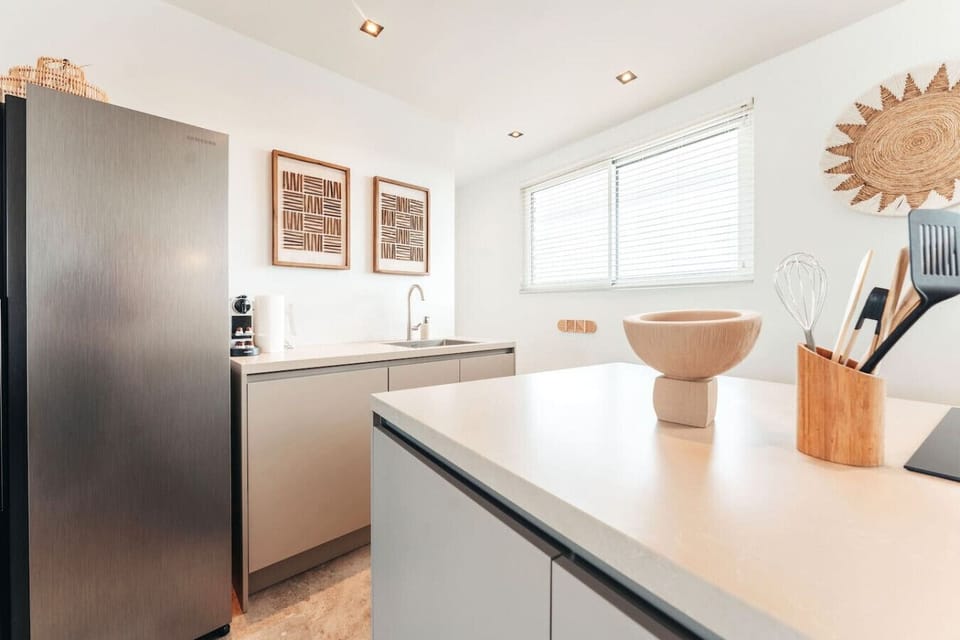 Bright, clean, and fully equipped—this kitchen makes it easy to whip up your favorite meals or enjoy a laid-back breakfast with plenty of natural light.