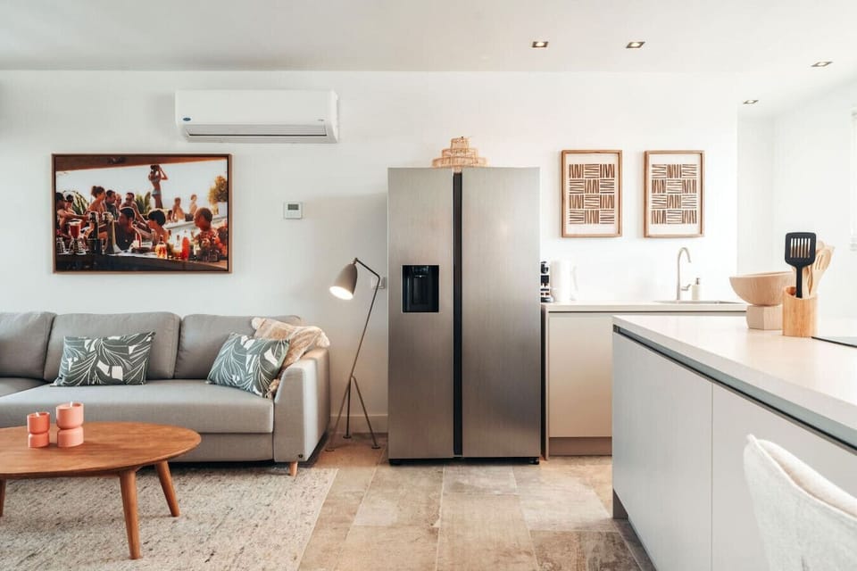 Modern, bright, and perfectly laid out—this space brings together a sleek kitchen and comfy living area, making it easy to cook, lounge, and feel right at home.