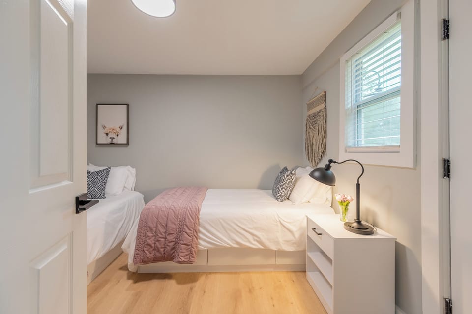 Comfortable and cozy twin bedroom with two windows and a relaxed vibe.